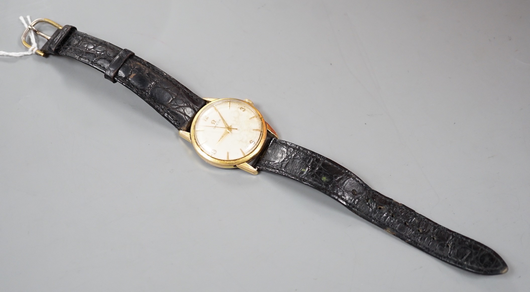 A gentleman's steel and gold plated Omega manual wind wrist watch, on associated leather strap.